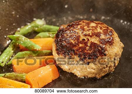 Picture - Grilling burg steak. Fotosearch