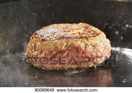 Stock Photo - Grilling burg steak. Fotosearch