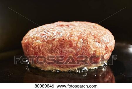Stock Photography - Grilling burg steak. Fotosearch