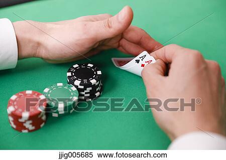 Stock Photography - Hand closeup betting on baccarat table. Fotosearch