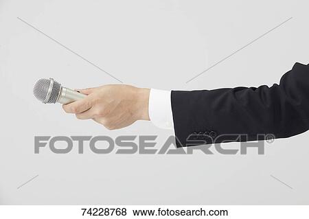 Hand holding microphone View Large Photo Image Stock Photo - Hand holding microphone. Fotosearch