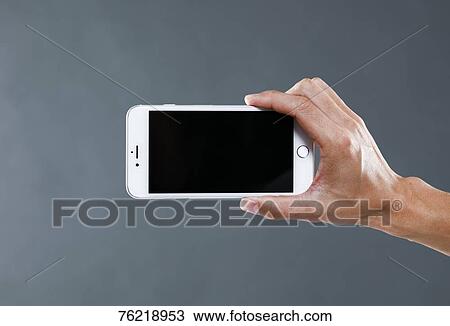 Hand holding smartphone View Large Photo Image Stock Image - Hand holding smartphone. Fotosearch
