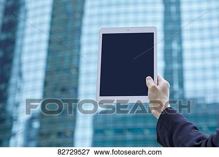 Hand holding tablet downtown Tokyo View Large Photo Image Stock Photo - Hand holding tablet downtown Tokyo. Fotosearch