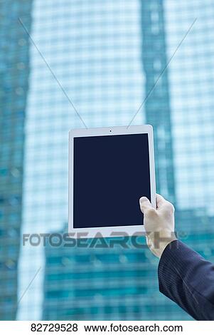 Hand holding tablet downtown Tokyo View Large Photo Image Stock Photo - Hand holding tablet downtown Tokyo. Fotosearch