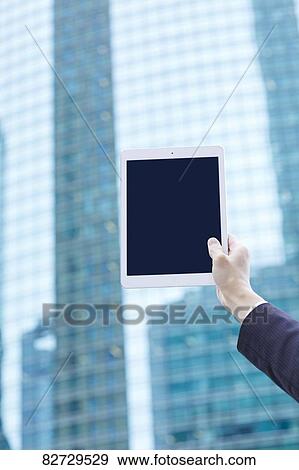 Hand holding tablet downtown Tokyo View Large Photo Image Stock Photo - Hand holding tablet downtown Tokyo. Fotosearch