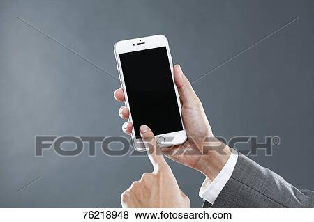 Hands holding smartphone View Large Photo Image Stock Photo - Hands holding smartphone. Fotosearch