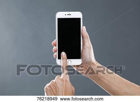 Hands holding smartphone View Large Photo Image Stock Photo - Hands holding smartphone. Fotosearch