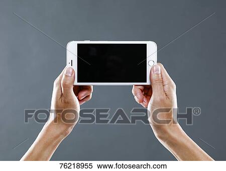 Stock Photography - Hands holding smartphone. Fotosearch