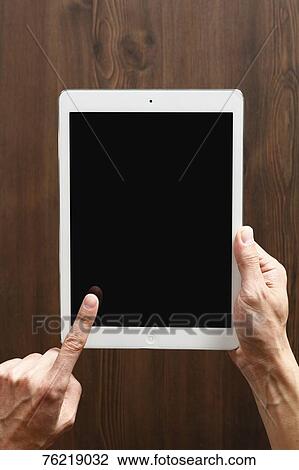 Stock Image - Hands holding tablet. Fotosearch