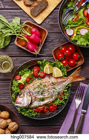 Picture - Healty and colorful grilled fish and vegetables. Fotosearch