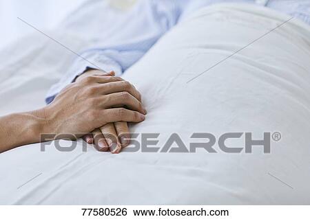 Holding hand of patient in bed View Large Photo Image Stock Photograph - Holding hand of patient in bed. Fotosearch