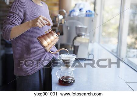 Stock Image - Japanese bartender preparing coffee. Fotosearch