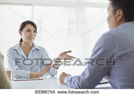 Picture - Japanese business people at work. Fotosearch