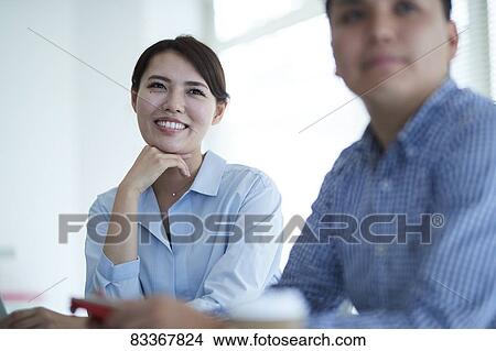Picture - Japanese business people at work. Fotosearch