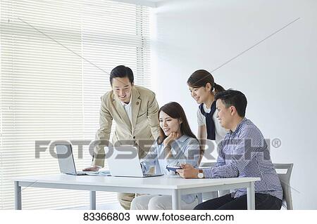 Stock Image - Japanese business people at work. Fotosearch