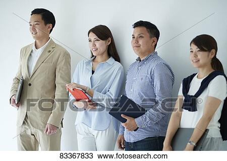 Stock Image - Japanese business people at work. Fotosearch