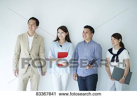 Stock Image - Japanese business people at work. Fotosearch