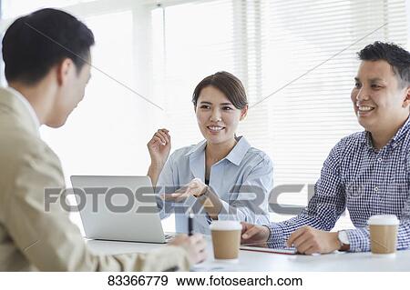 Stock Photo - Japanese business people at work. Fotosearch
