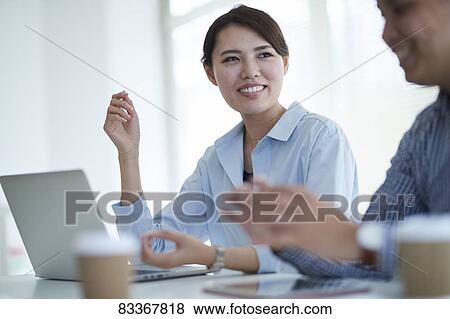 Stock Photo - Japanese business people at work. Fotosearch