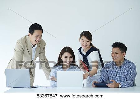 Stock Photo - Japanese business people at work. Fotosearch
