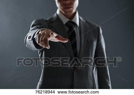 Picture - Japanese businessman against grey background. Fotosearch