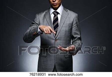 Japanese businessman against grey background View Large Photo Image Stock Image - Japanese businessman against grey background. Fotosearch