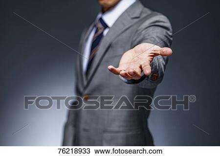 Japanese businessman against grey background View Large Photo Image Stock Image - Japanese businessman against grey background. Fotosearch