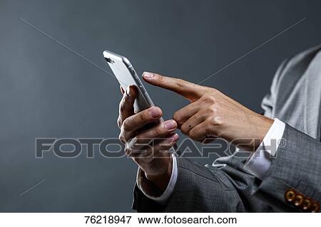 Stock Photo - Japanese businessman against grey background. Fotosearch