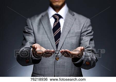 Japanese businessman against grey background View Large Photo Image Stock Photograph - Japanese businessman against grey background. Fotosearch