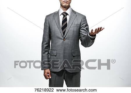 Stock Image - Japanese businessman against white background. Fotosearch