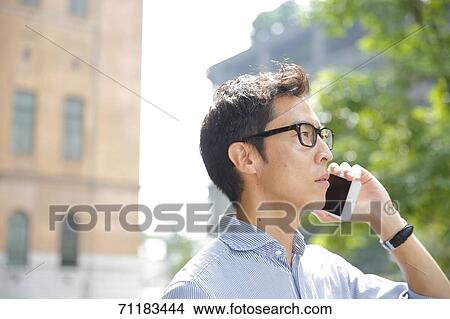 Picture - Japanese businessman downtown Tokyo. Fotosearch