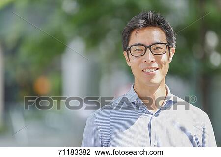 Stock Image - Japanese businessman downtown Tokyo. Fotosearch