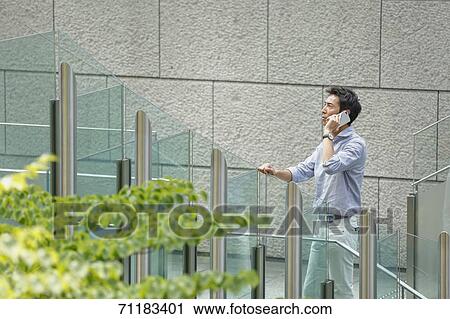 Stock Image - Japanese businessman downtown Tokyo. Fotosearch