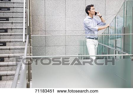 Stock Image - Japanese businessman downtown Tokyo. Fotosearch