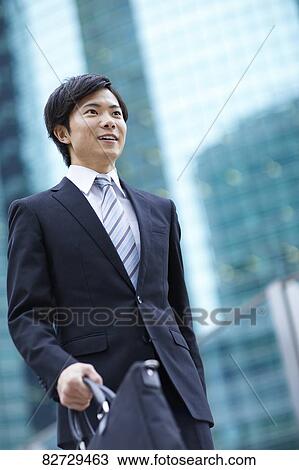Stock Image - Japanese businessman downtown Tokyo. Fotosearch