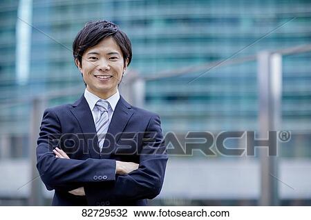 Stock Image - Japanese businessman downtown Tokyo. Fotosearch