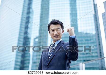 Stock Image - Japanese businessman downtown Tokyo. Fotosearch