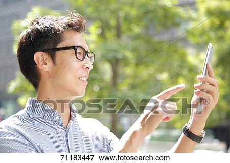 Stock Photo - Japanese businessman downtown Tokyo. Fotosearch