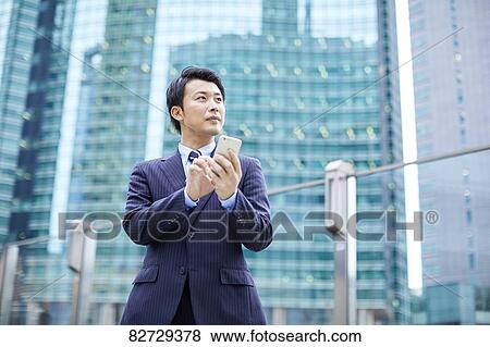 Stock Photo - Japanese businessman downtown Tokyo. Fotosearch