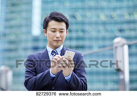 Stock Photograph - Japanese businessman downtown Tokyo. Fotosearch