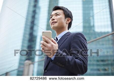 Stock Photograph - Japanese businessman downtown Tokyo. Fotosearch