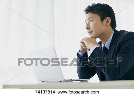 Picture - Japanese businessman in the office. Fotosearch