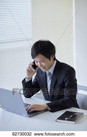Stock Image - Japanese businessman in the office. Fotosearch