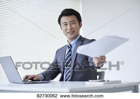 Stock Image - Japanese businessman in the office. Fotosearch