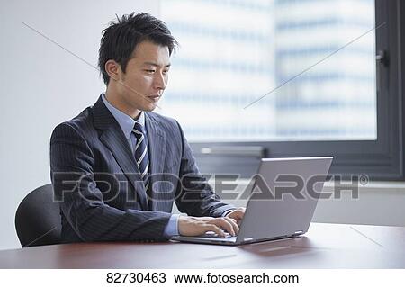 Stock Image - Japanese businessman in the office. Fotosearch