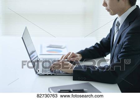 Stock Image - Japanese businessman in the office. Fotosearch