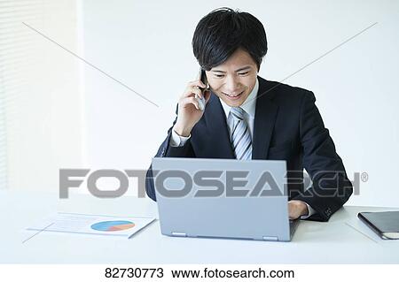 Stock Image - Japanese businessman in the office. Fotosearch