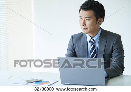 Stock Image - Japanese businessman in the office. Fotosearch