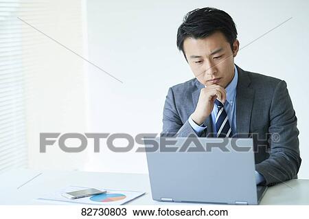 Stock Image - Japanese businessman in the office. Fotosearch