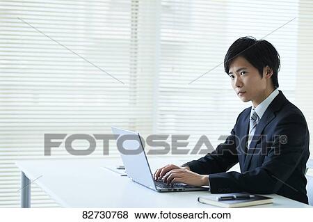 Stock Photo - Japanese businessman in the office. Fotosearch